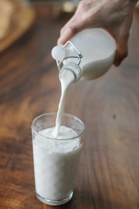 Milk being poured from a bottle to a glass